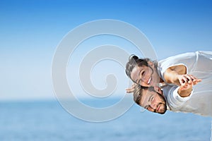 Beach couple laughing in love romance on travel honeymoon vacation