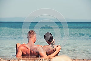 Beach couple on romantic travel honeymoon vacation summer holidays romance. Young happy lovers, woman and Caucasian man
