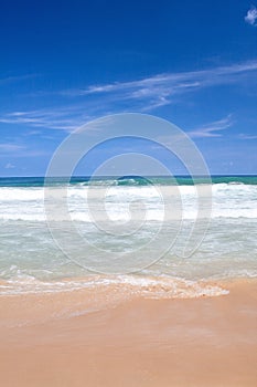 Beach with crashing waves in the tropics