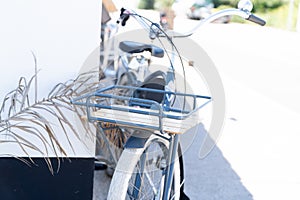 Beach cruiser Bicycle standing in front of building on old street bike with basket front