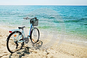 Beach cruiser bike with female frame over clear sea water background.