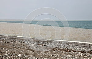 Beach with dirty muddy water, sea pollution, environmental disaster