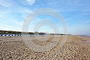 Beach district called `Paal 20` with beach huts in distance on island Texel in the netherlands on summer day with blue sky