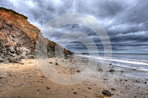 Beach, Dramatic Sky, Stormy Clouds, showing coastal erosion of cliffs