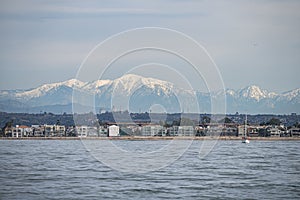 Beach and DTLA skyline with snow capped mountains