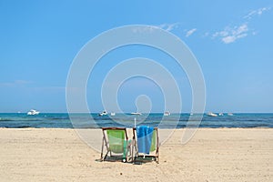 Beach with empty chairs