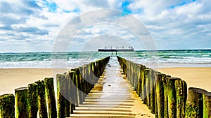 Beach erosion protection with a Large Ocean Freighter coming from the North Sea in the background and heading Vlissingen harbor