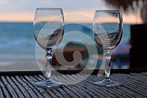 Beach evening on the sunset with two glasses