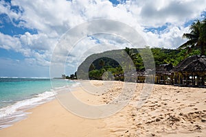 Beach fale`s on a white sand beach at Lalomanu, Samoa