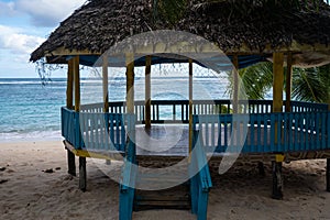 Beach fale`s on a white sand beach at Lalomanu, Samoa