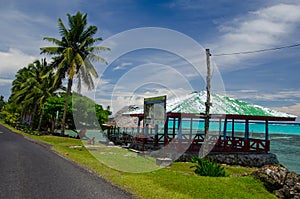 Beach fales surrounded by greenery and sea under the sunlight in Savai'i Island, Samoa