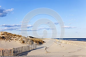 Beach Fence, Sand, Houses and the Ocean.