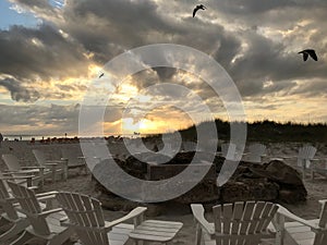 Beach fire circle with clouds and seagulls