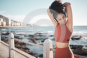 Beach, fitness and woman doing a stretching exercise before running or training for a race or marathon. Health, sports