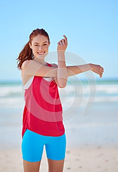 Beach, fitness and woman stretching arms in training to warm up body for running exercise or workout. Smile, portrait