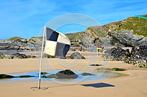 Beach flags, Lusty Glaze beach, Newquay in Cornwall