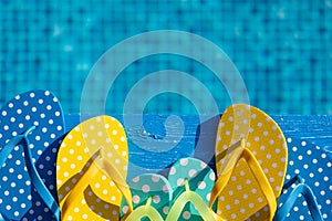 Beach flip-flops on blue wooden background