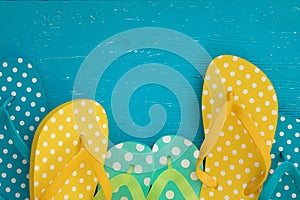 Beach flip-flops on blue wooden background