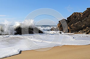 Beach with foaming waves photo