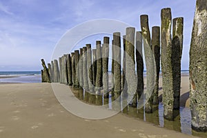 Beach in france with wooden poles and the cahnnel between france and england