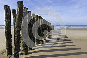Beach in france with wooden poles and the channel between france and england