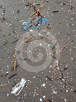 the beach is full of scattered rubbish. marine trash