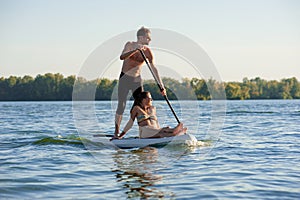 Beach fun couple on stand up paddle board SUP02