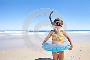Beach, fun and girl child with swimming inflatable, snorkel and excited against ocean background. Adventure, portrait