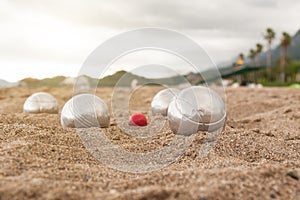 Beach. A game of Bocha. Brilliant silver balls for a bocha on the sand.