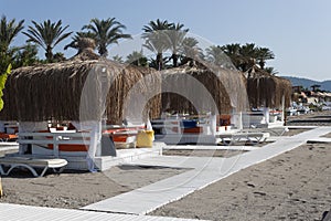 Beach gazebo with lounge chairs by the sea in Camyuva