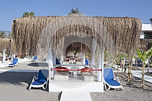 Beach gazebo with lounge chairs by the sea in Camyuva