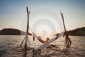 Beach getaway, relaxation in hammock at sunset, paradise remote island holidays