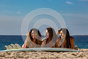 Beach girls having fun with surfboard