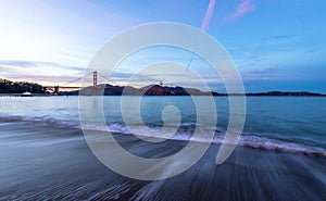 Beach and Golden Gate Bridge at sunset - San Francisco, California, USA