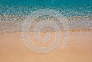 Beach with golden sand, turquoise ocean water. Panoramic sea view. Natural background for summer vacation.