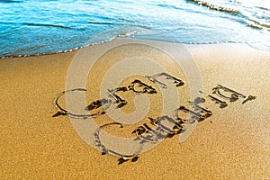 Beach. Gran Canaria is written on the sea sand photo