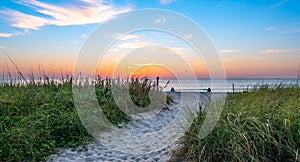 Beach and grass dunes at sunrise.