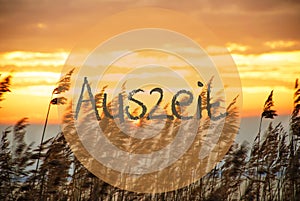 Beach Grass At Sunrise Or Sunset, Text Auszeit Means Downtime photo
