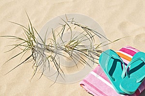 Beach grass towel and flip-flops.