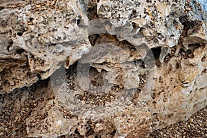 Beach, gray sand and  pebbles, natural stone figure