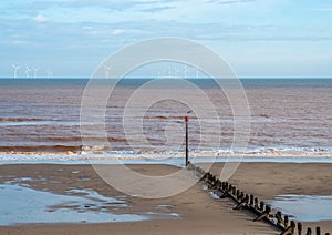 Beach groin leading to wind farm