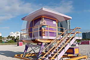 Beach guard. Man stand on lifeguard tower. Beach vacation. Summer break. Seaside holidays