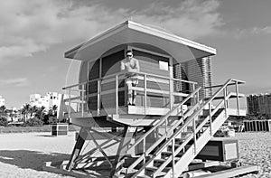 Beach guard. Man stand on lifeguard tower. Beach vacation. Summer break. Seaside holidays