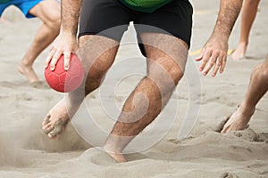 Beach handball players in action