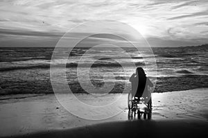 Beach handicapped woman in wheelchair.