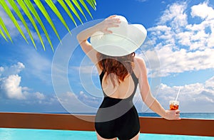 Beach hat rear view woman cocktail tropical beach