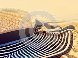 Beach hat wide large brim on a beach at sunset