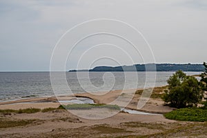 The beach of HavÃ¤ng is empty and in the distance the mountain and national park Stenshuvud is visible on the horizon