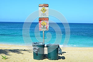 Beach hazard signs and dustbins