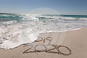 Beach holiday with 2020 in the sand